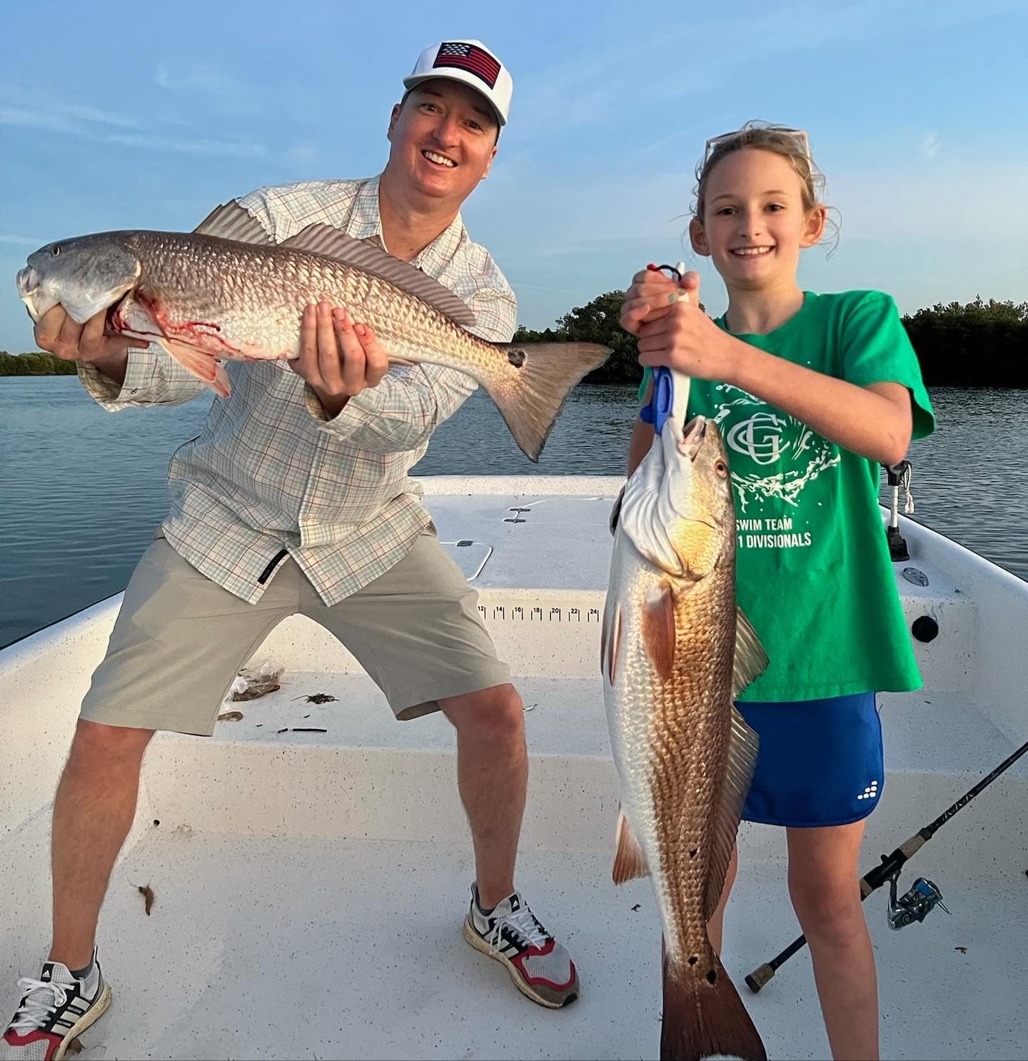 Anglers holding large redfish on guided Crystal River flats, Florida
