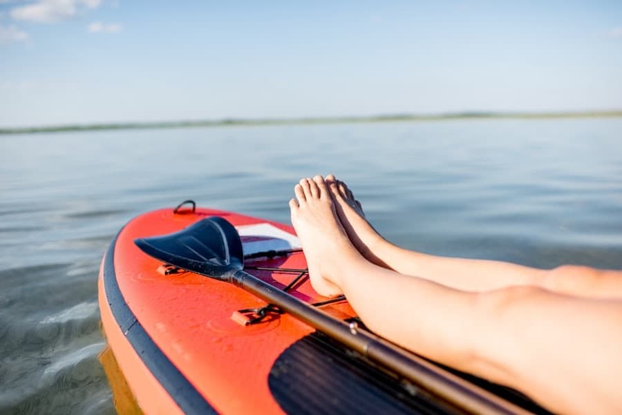 Relaxing on inflatable kayak legs up on calm open water
