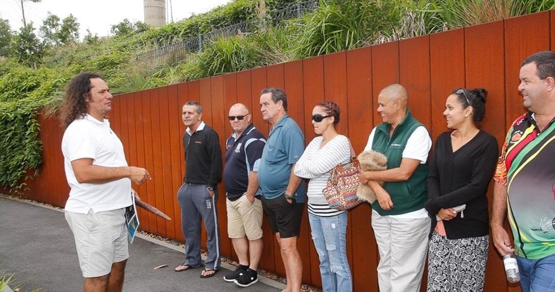 Small outdoor walking tour group listening to guide at Barangaroo