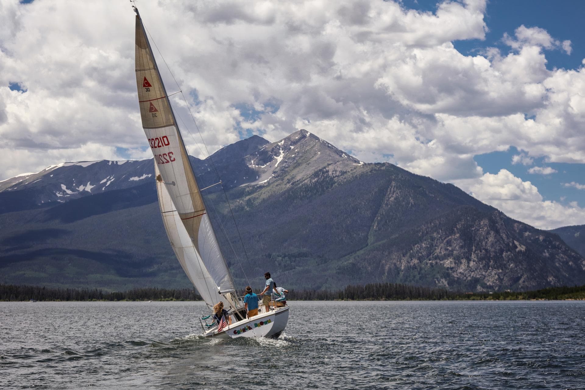 Sailboat racing on Dillon Reservoir with mountain backdrop