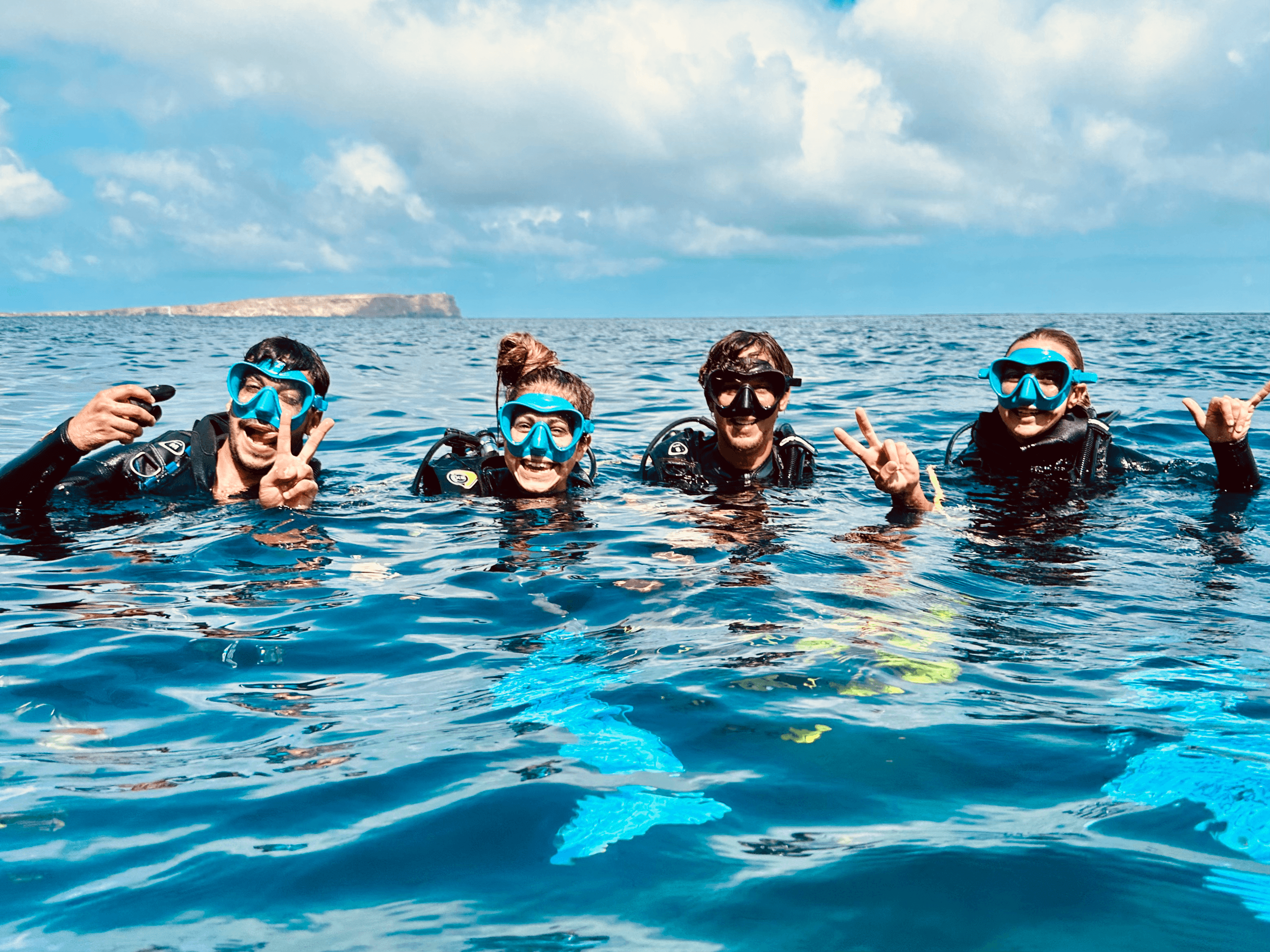 Friends snorkeling and smiling at surface in Mediterranean sea