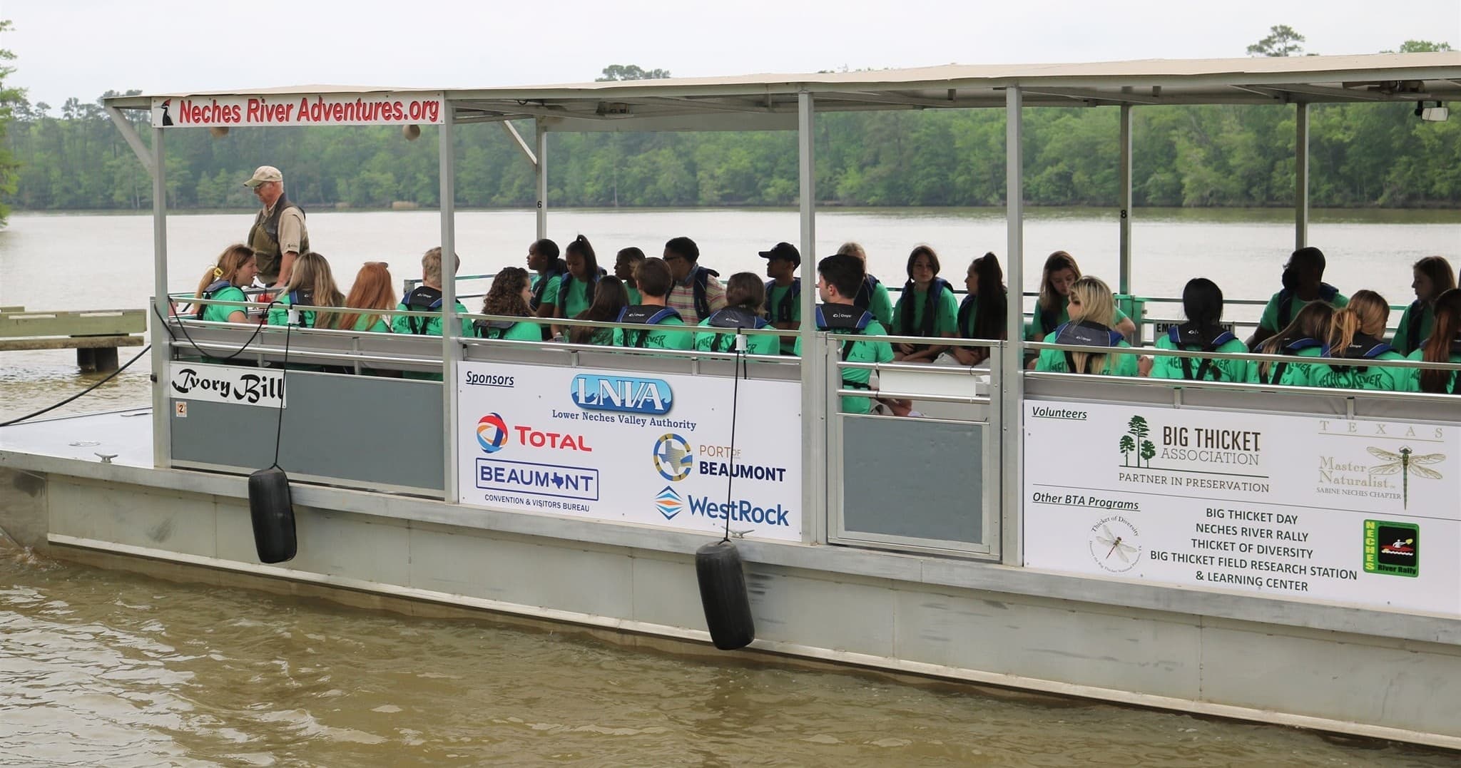 Crowded riverboat tour on muddy river, educational guided trip