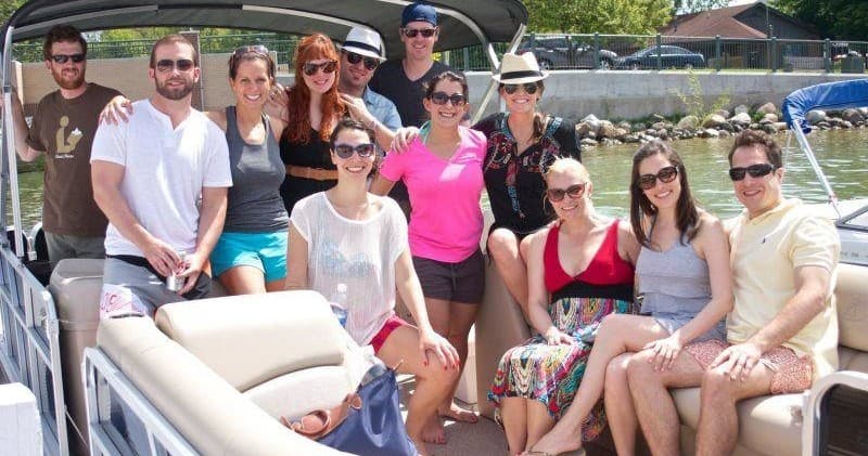 Group enjoying pontoon boat cruise on sunny inland lake