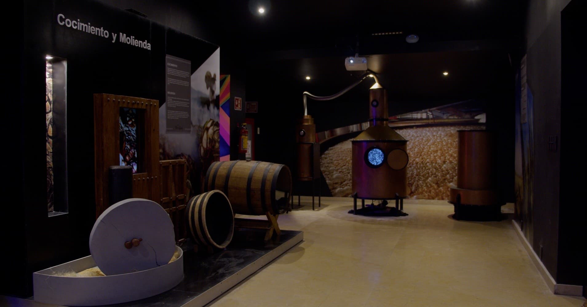 Tequila exhibit room with oak barrels and tasting displays indoors