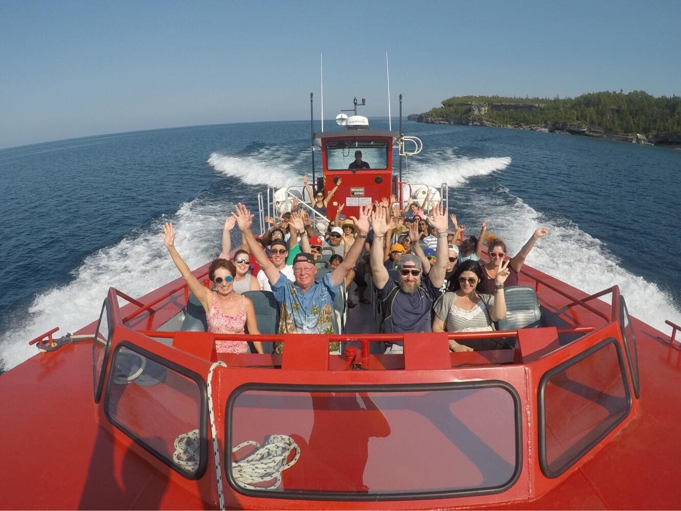 High-speed boat tour with cheering passengers on open lake