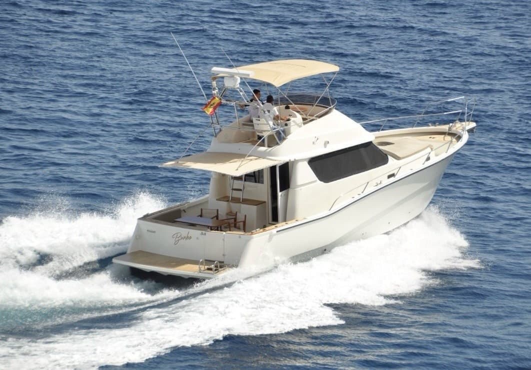 Motor yacht cruising open blue sea near coastline