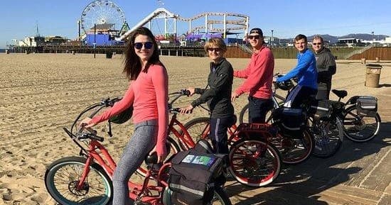 Group bike tour along Santa Monica beach with pier view