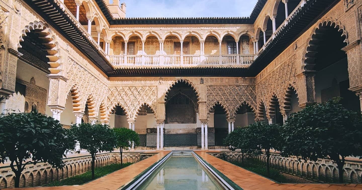 Moorish Alcazar courtyard with reflective pool in Seville
