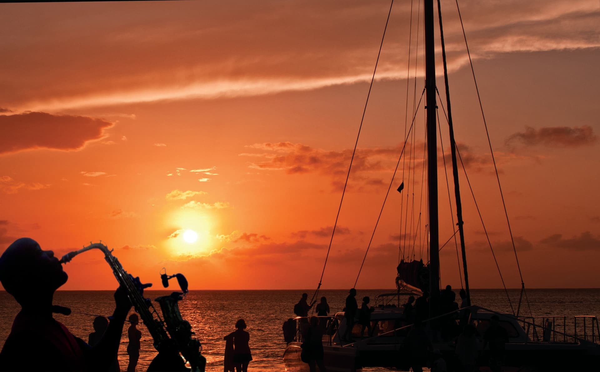 Sunset sailboats moored off a tropical Jamaican coastline