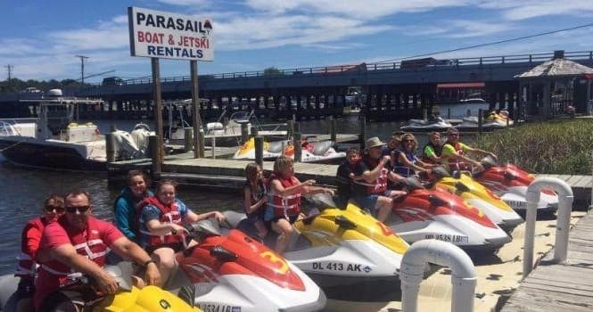 Row of rental jet skis lined on dock at waterfront marina