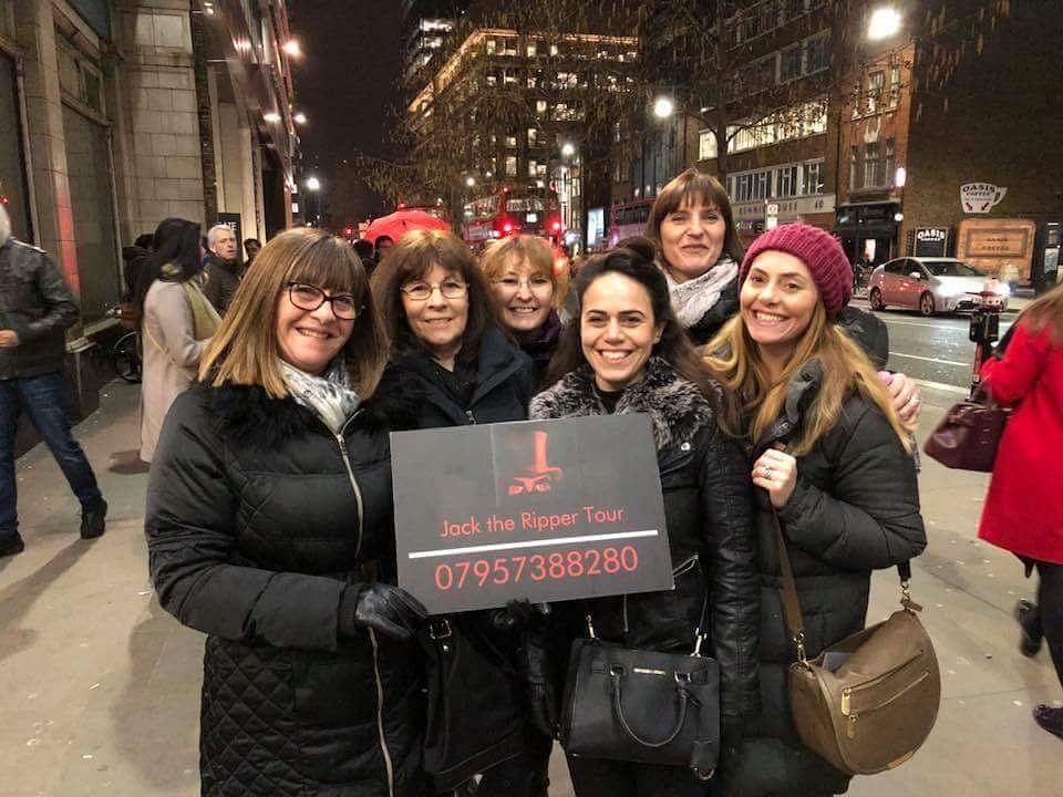 Nighttime Jack the Ripper walking tour group on London street