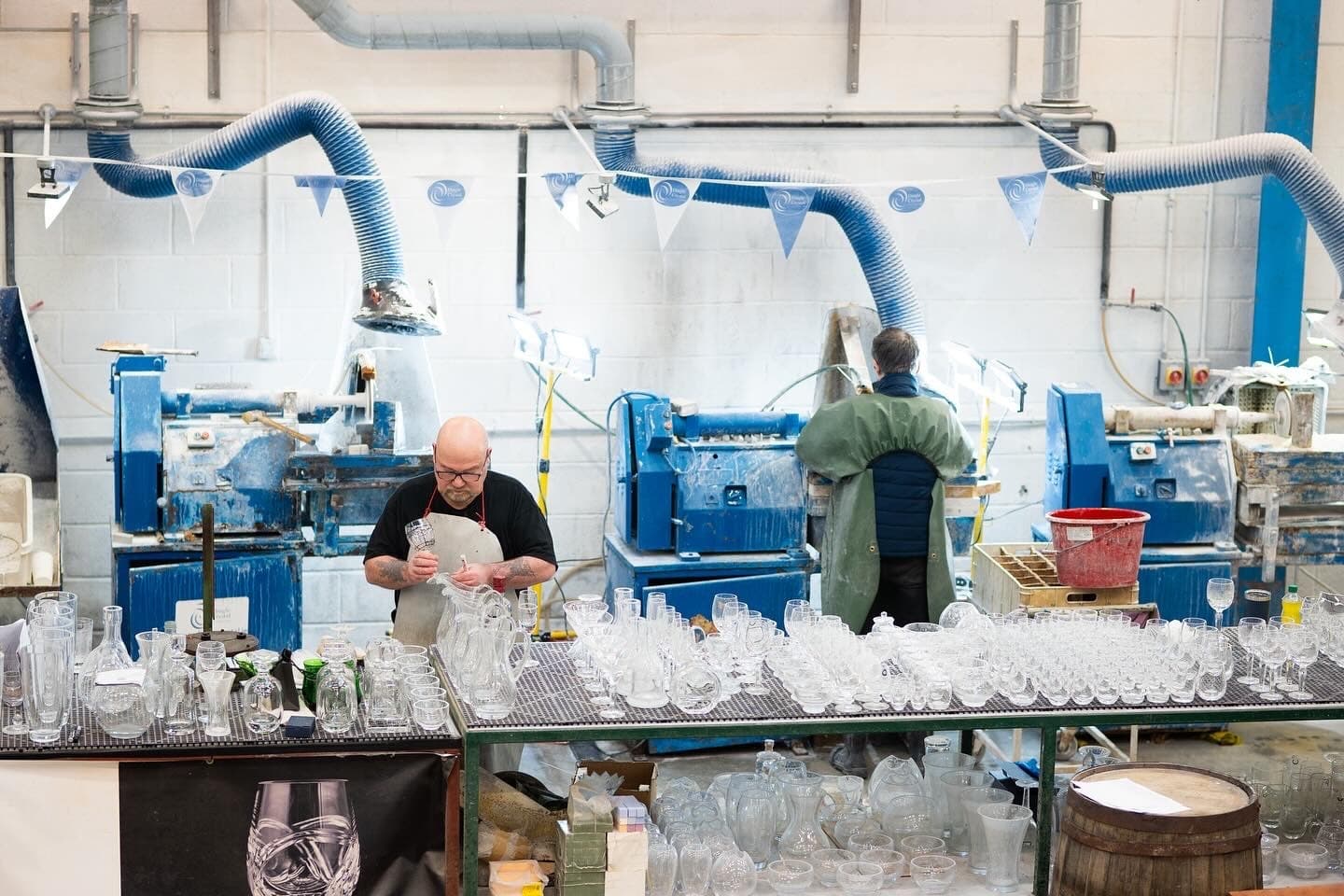 Artisans hand-finishing crystal glassware in Dingle indoor workshop
