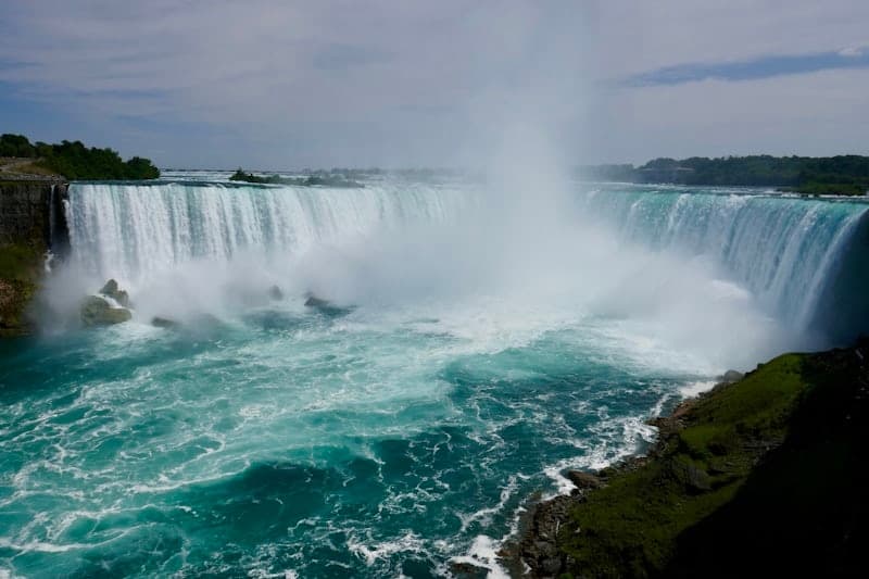Tourists view Horseshoe Falls at Niagara, powerful waterfall