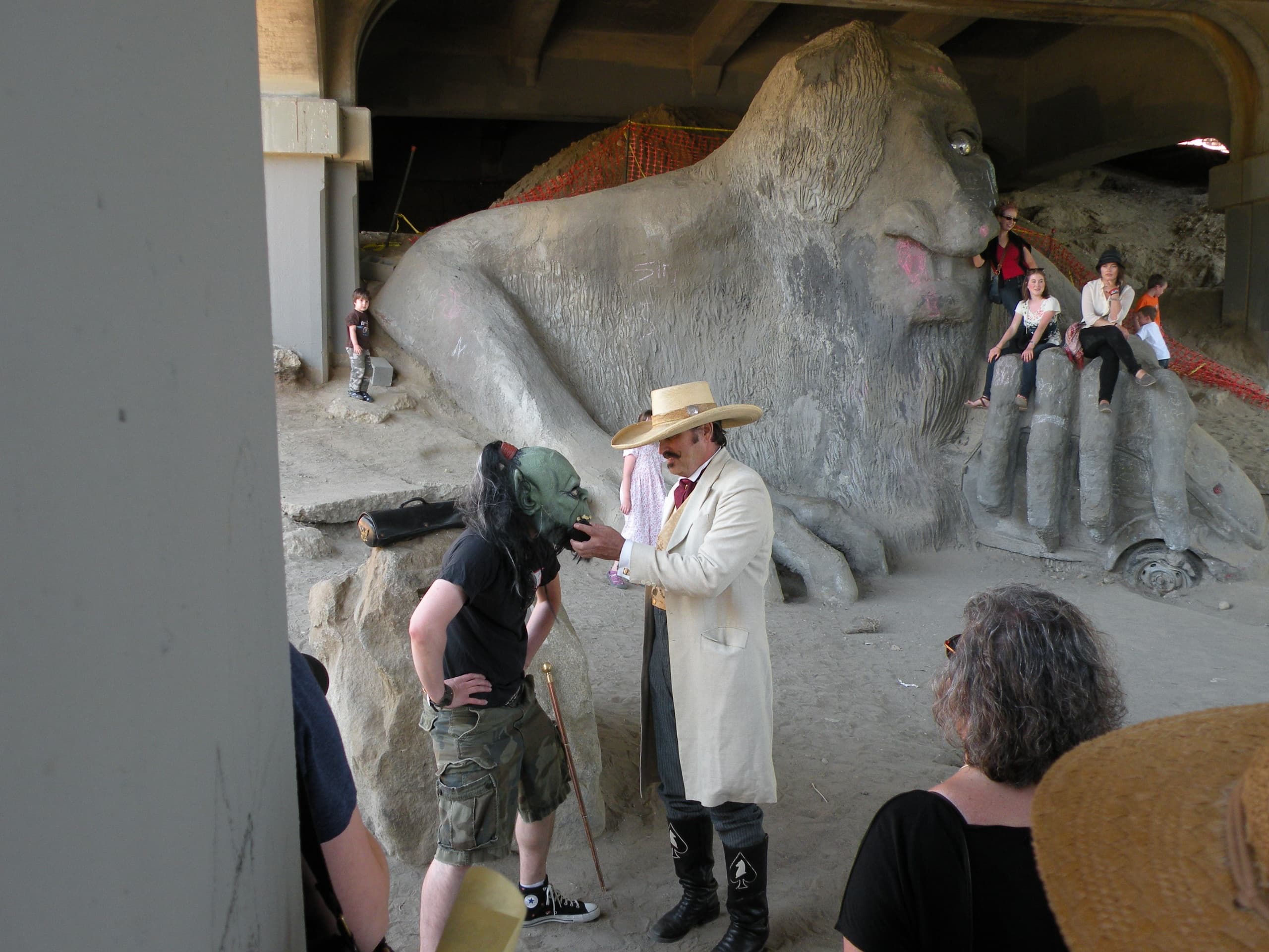 Visitors exploring the Fremont Troll sculpture under Seattle bridge walking tour