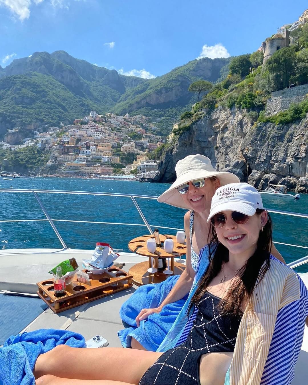 Couple on private boat touring Amalfi Coast cliffs and seaside