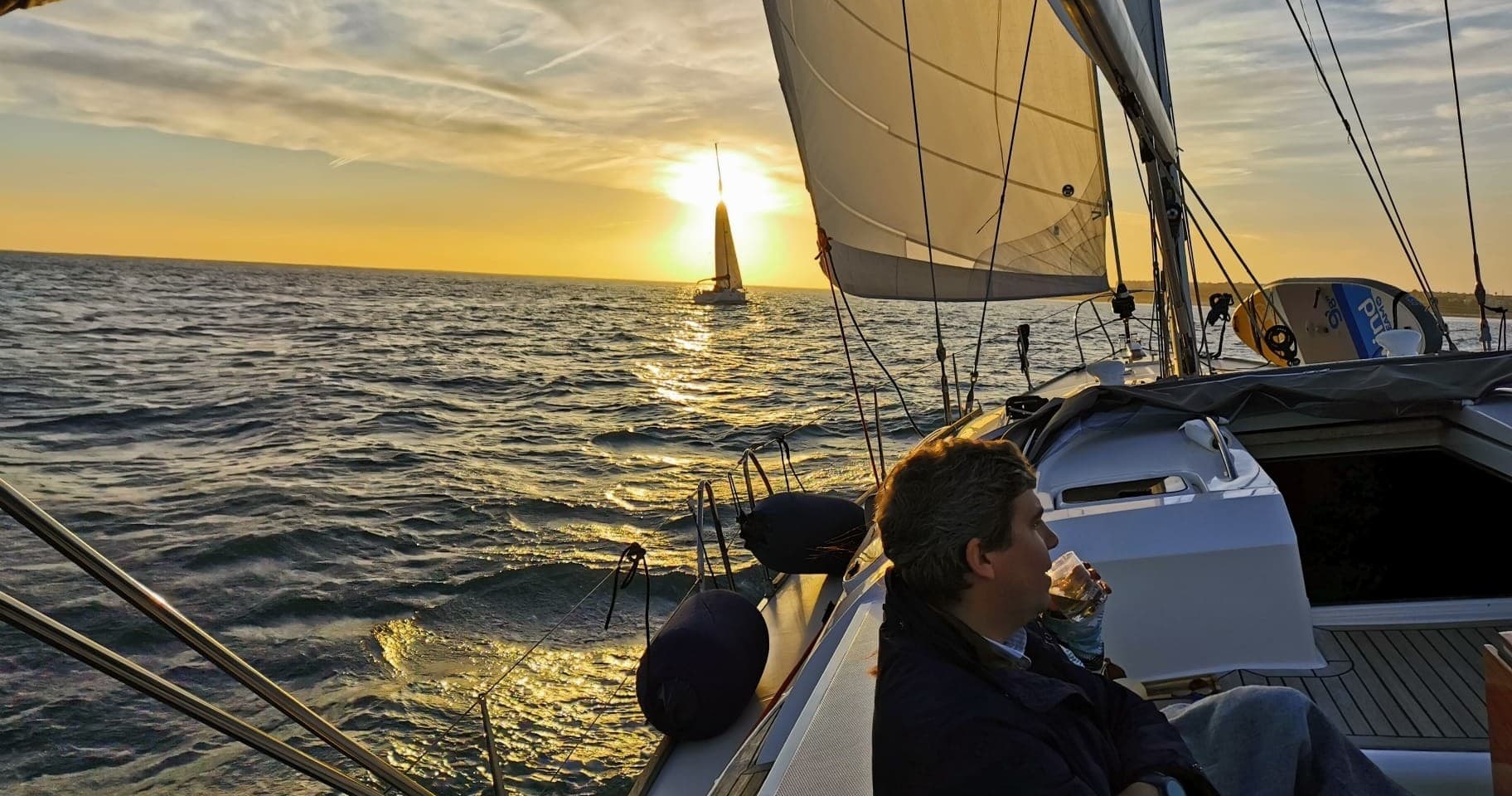 Couple sailing at sunset on a Lisbon bay evening cruise