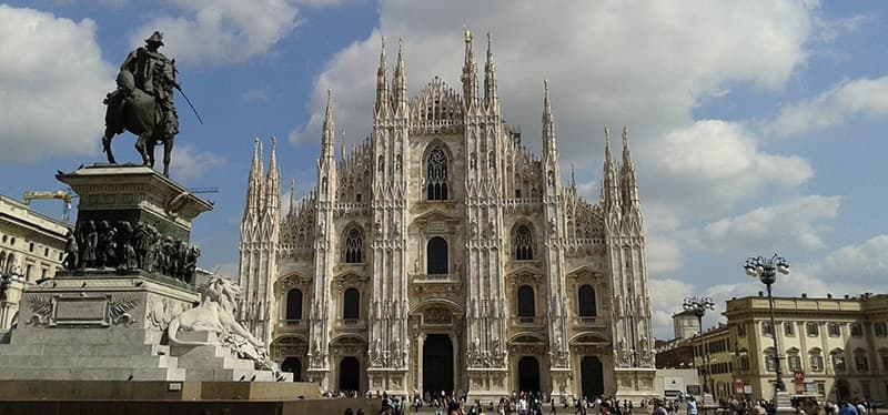 Sightseers admiring Milan Cathedral exterior at Piazza Duomo