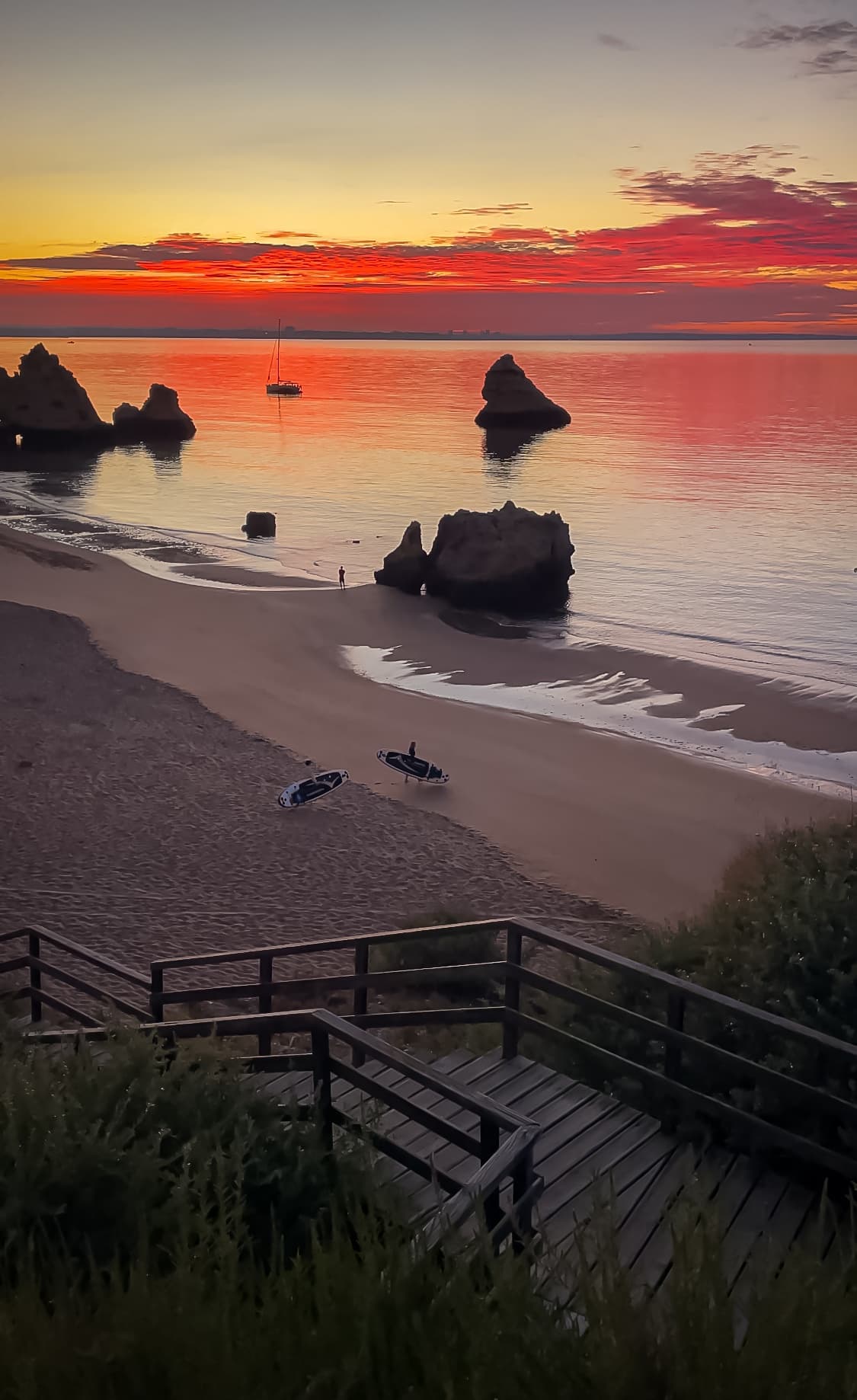 Sunset beach stairs and sea stacks on a tranquil coastal shore
