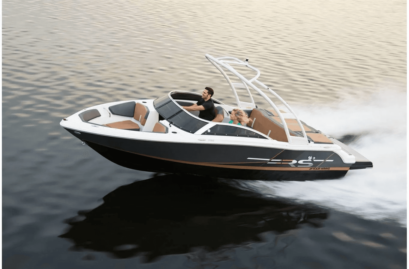 Sleek speedboat spraying water while cruising Lake Tahoe shoreline