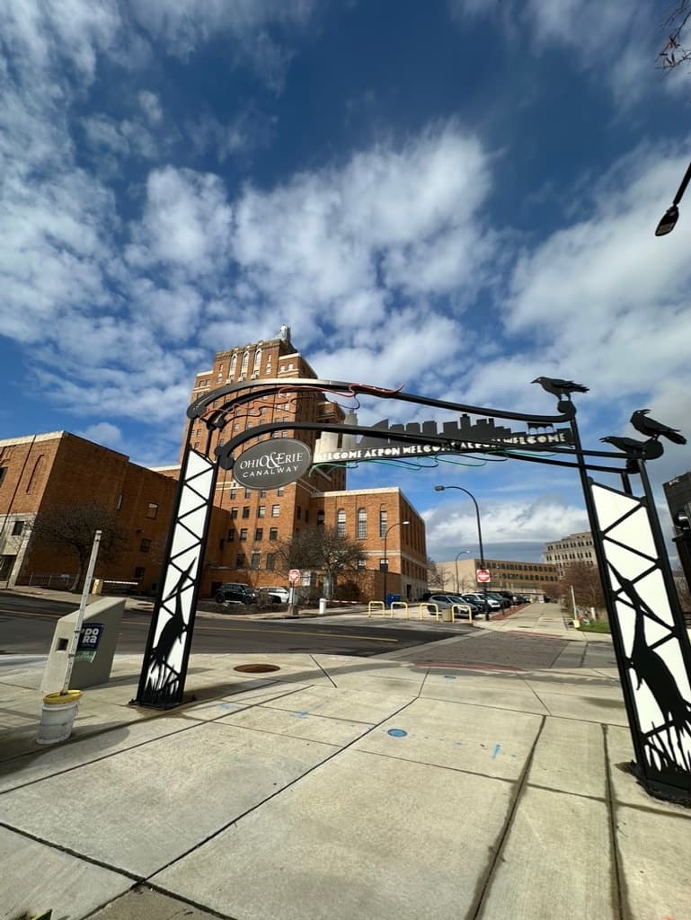 Historic downtown archway under blue sky on city walking tour