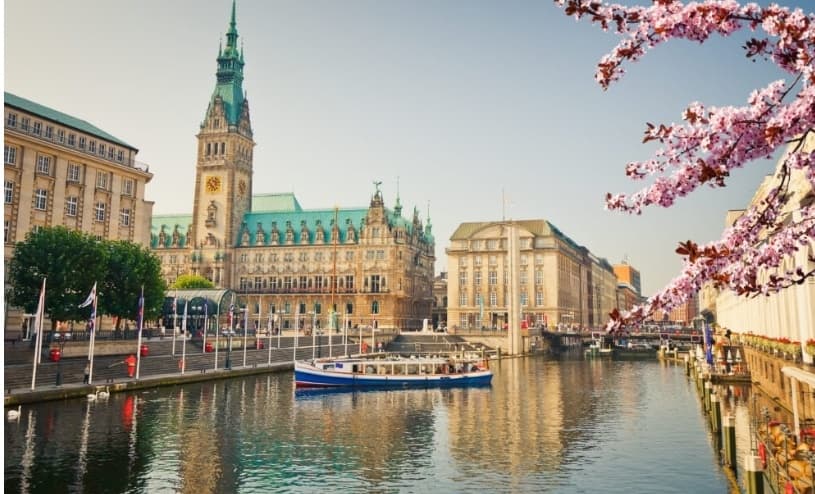 Historic Hamburg waterfront with Rathaus and canal boats
