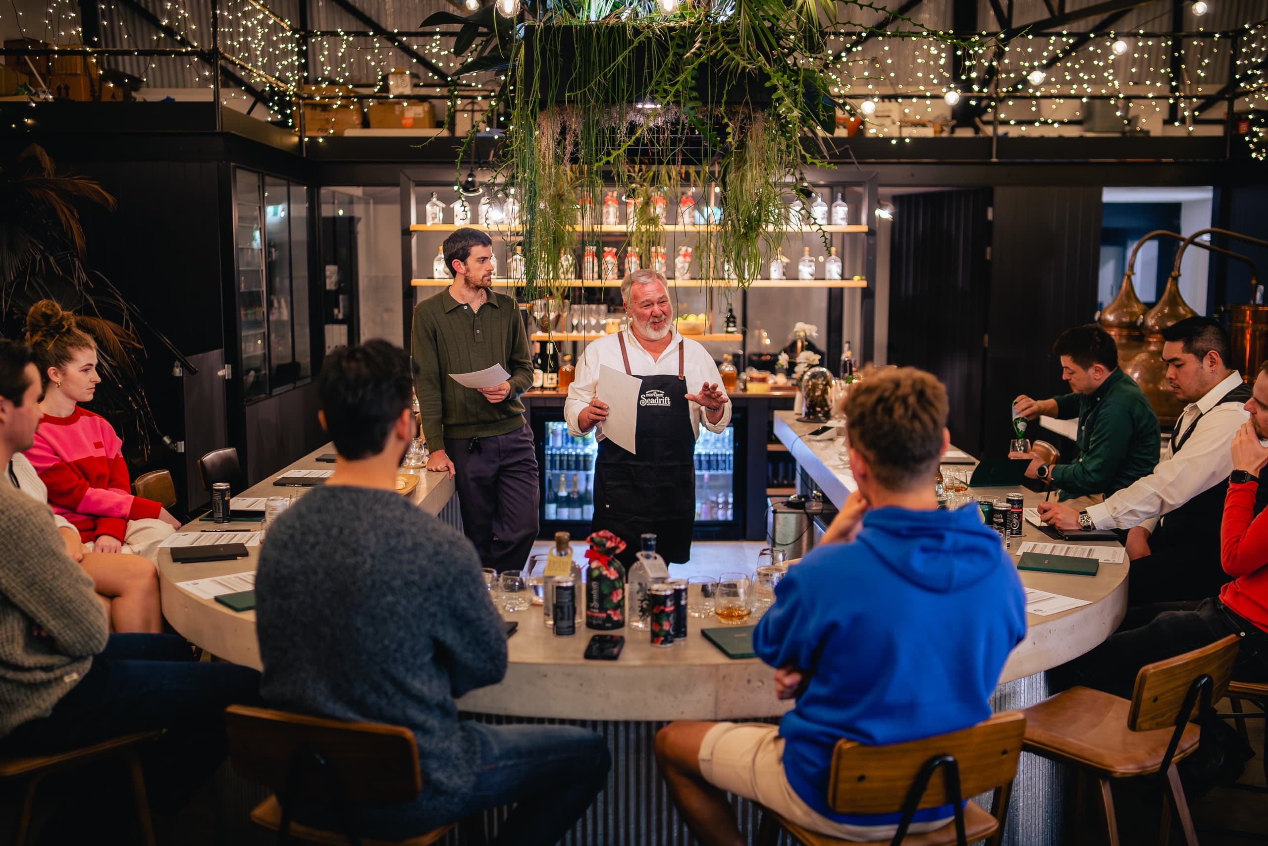 Spirits tasting at distillery bar with group seated during event