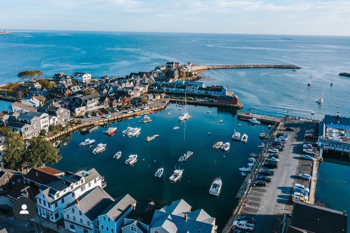 Aerial view of coastal harbor and marina with boats and docks