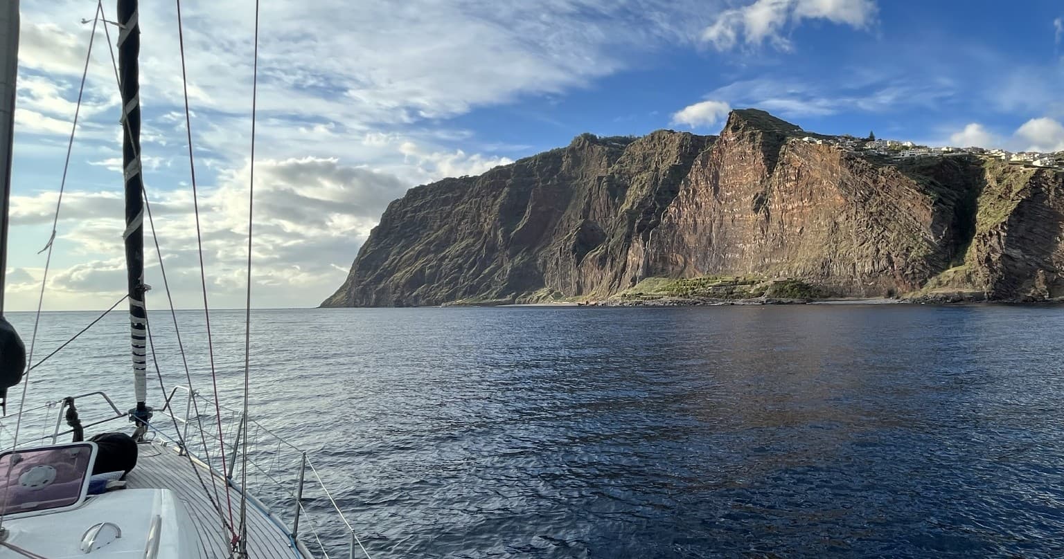 Panoramic coastal cliffs viewed from yacht during daytime sail