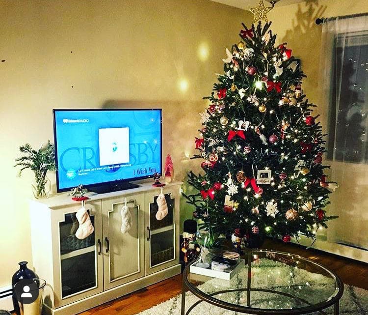 Festive living room Christmas tree with ornaments and stockings
