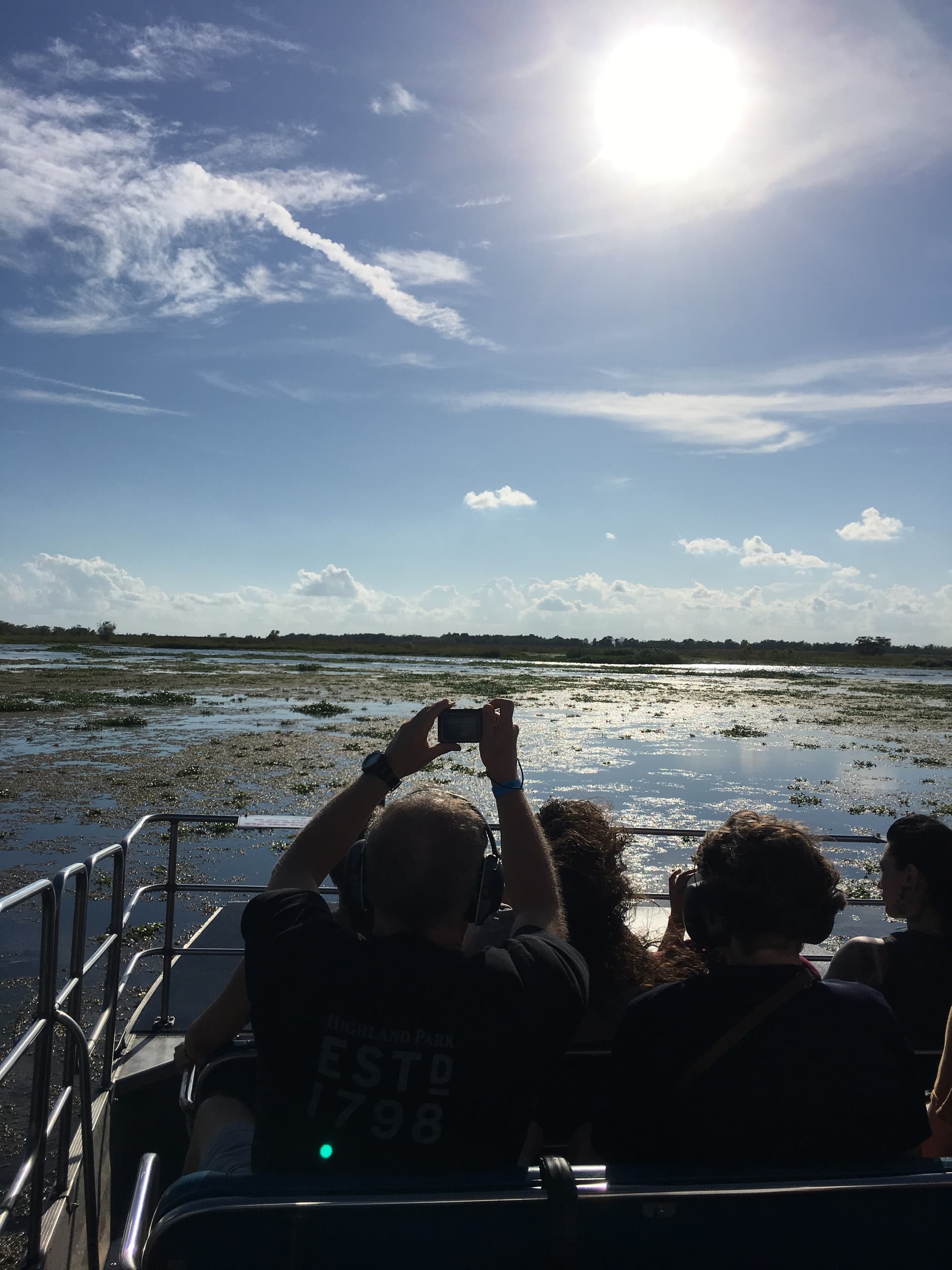 Eco boat tour across coastal marshes at sunrise with passengers