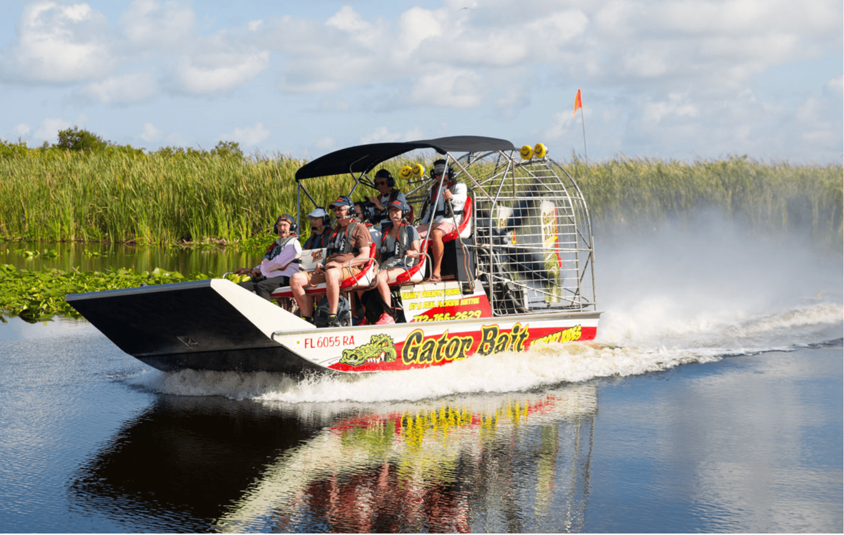 Airboat cutting through Everglades water on high-speed wildlife tour