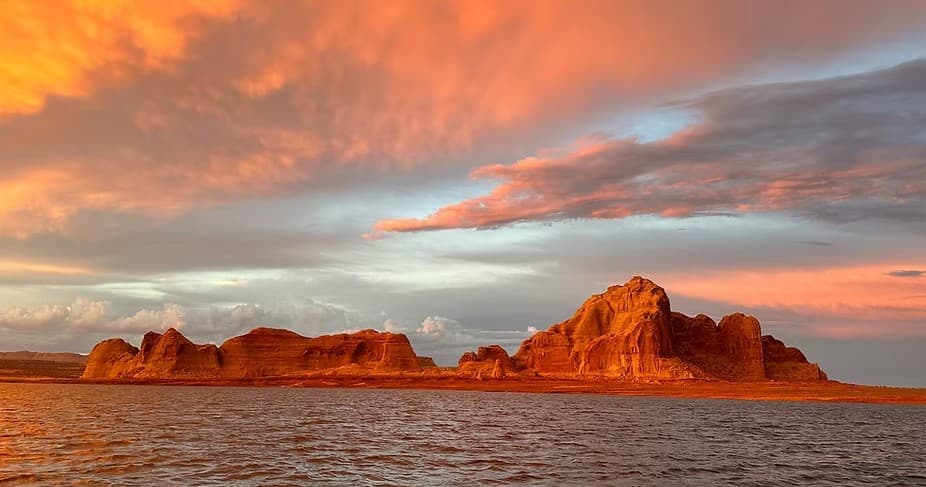 Sunset over red rock islands on Lake Powell shoreline