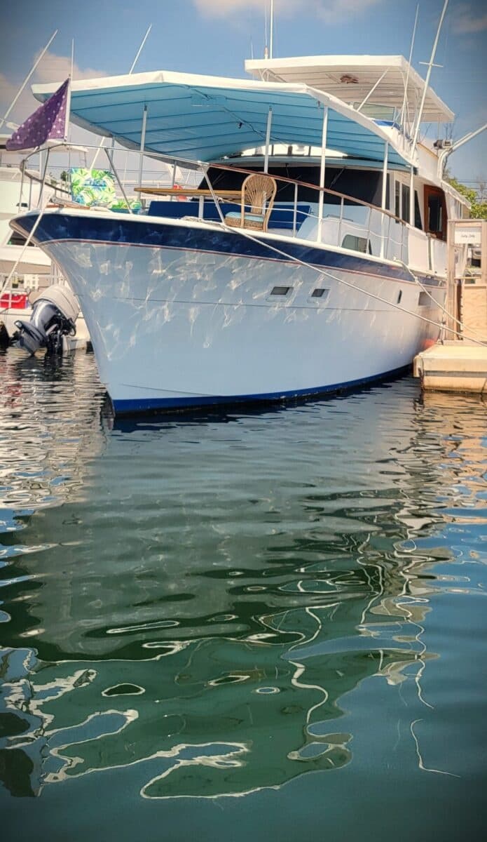 Motor yacht docked at Key West marina, serene water reflections