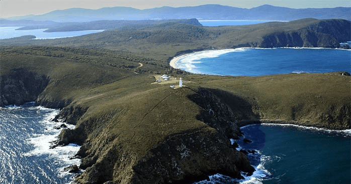 Coastal bay and lighthouse seen on panoramic scenic flight