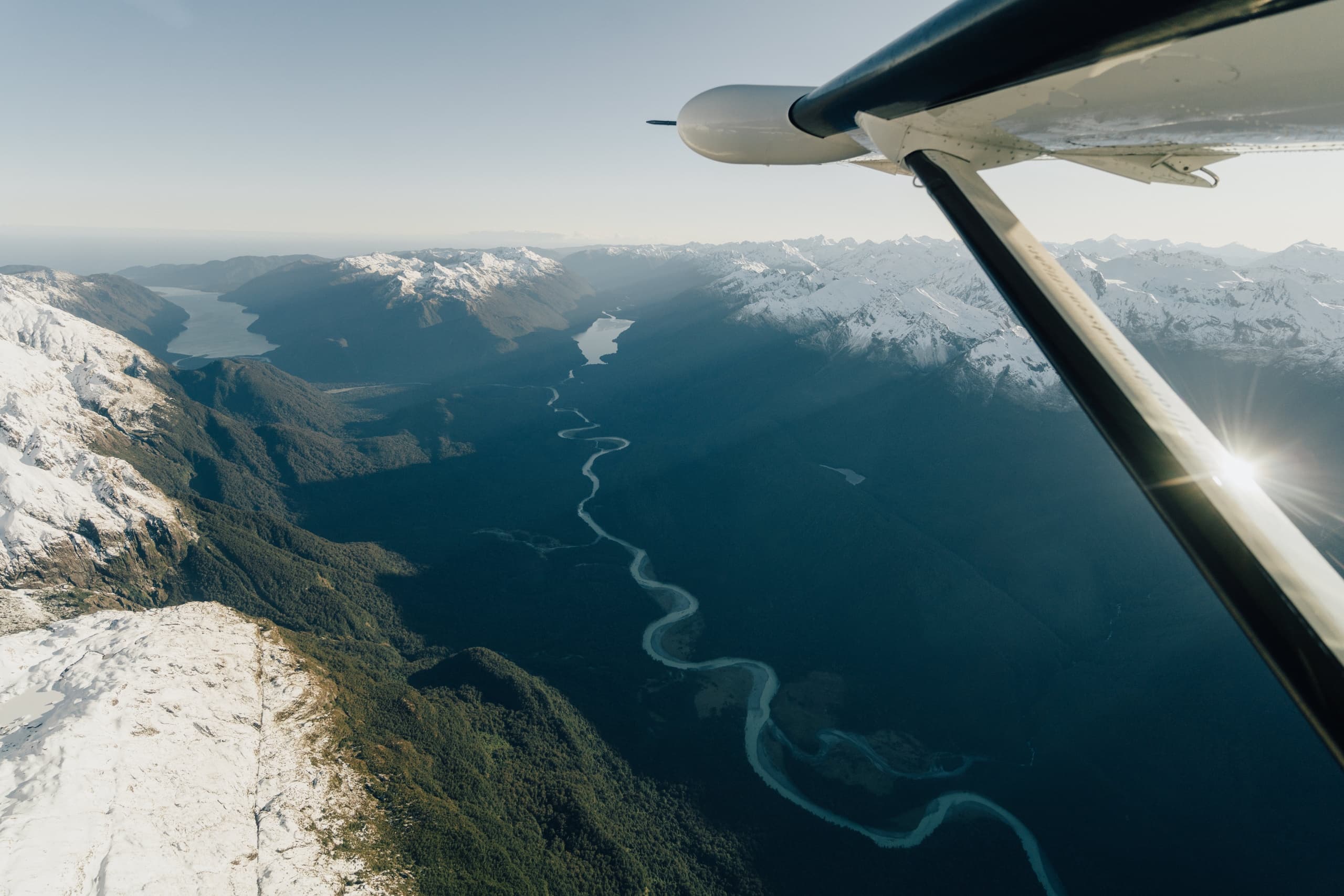 Aerial wing view of winding river and fjords in Fiordland
