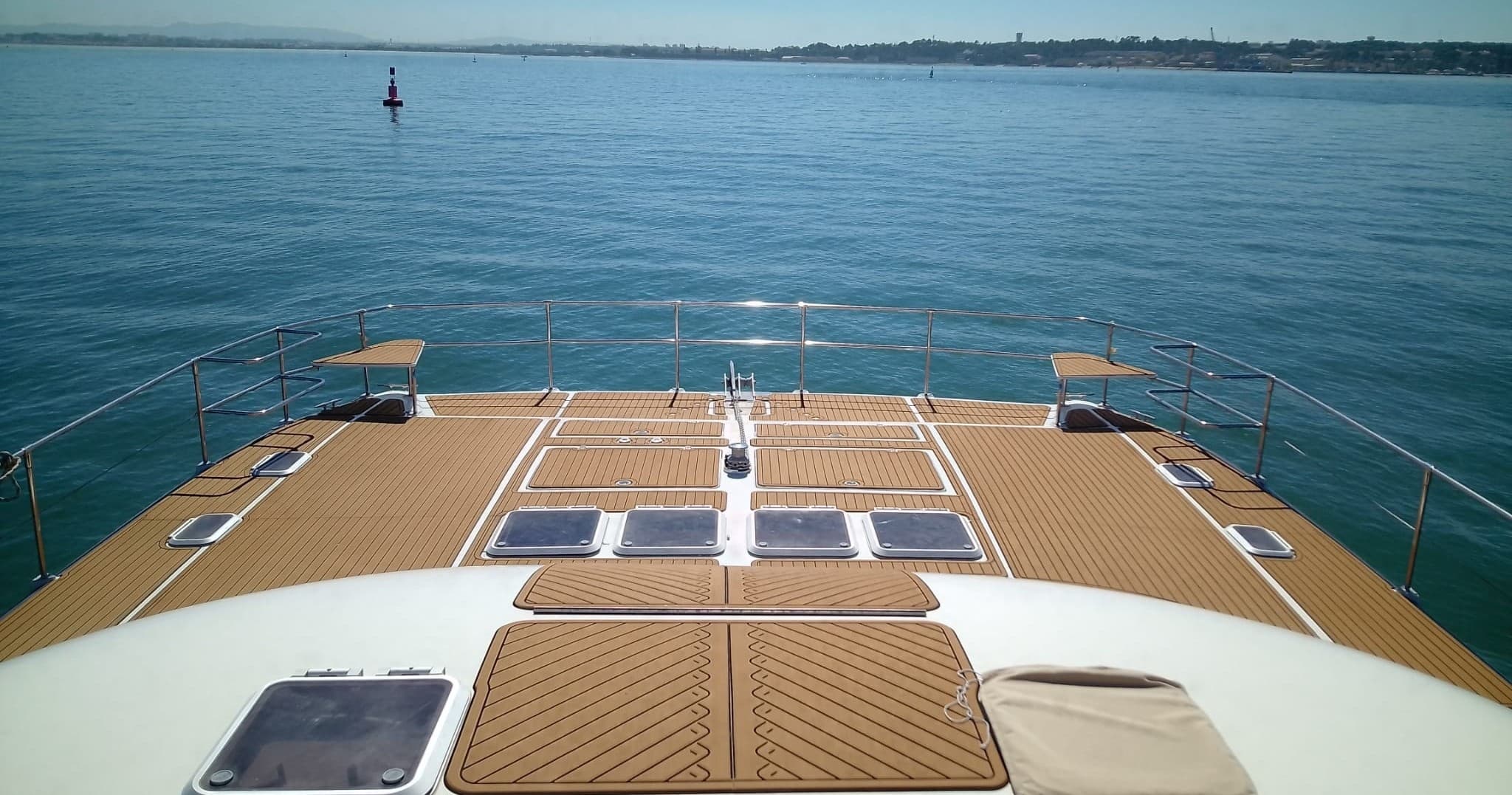 Catamaran bow cruising Lisbon coast with open sea horizon
