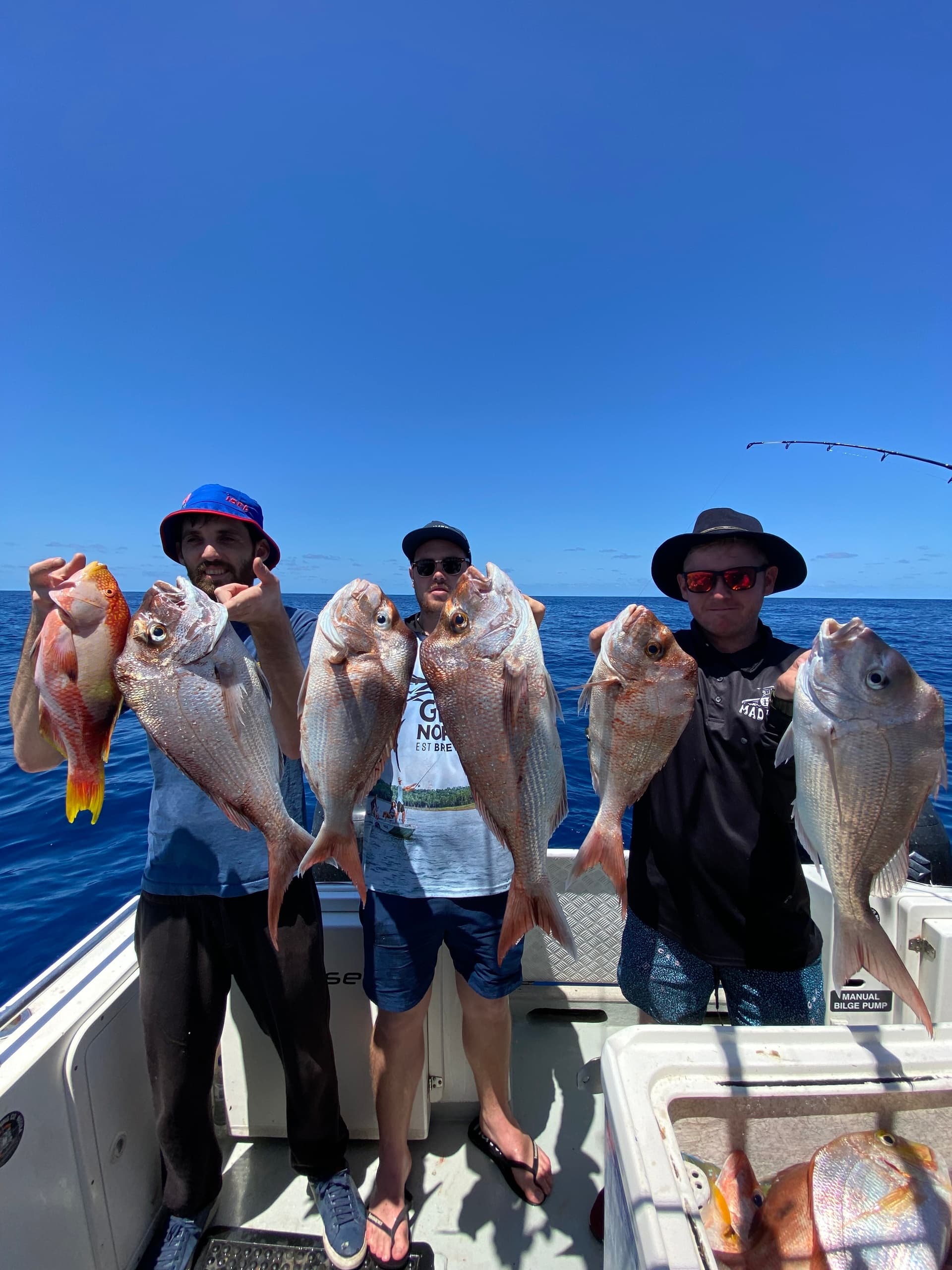 Group of anglers displaying multiple snapper catches on deck