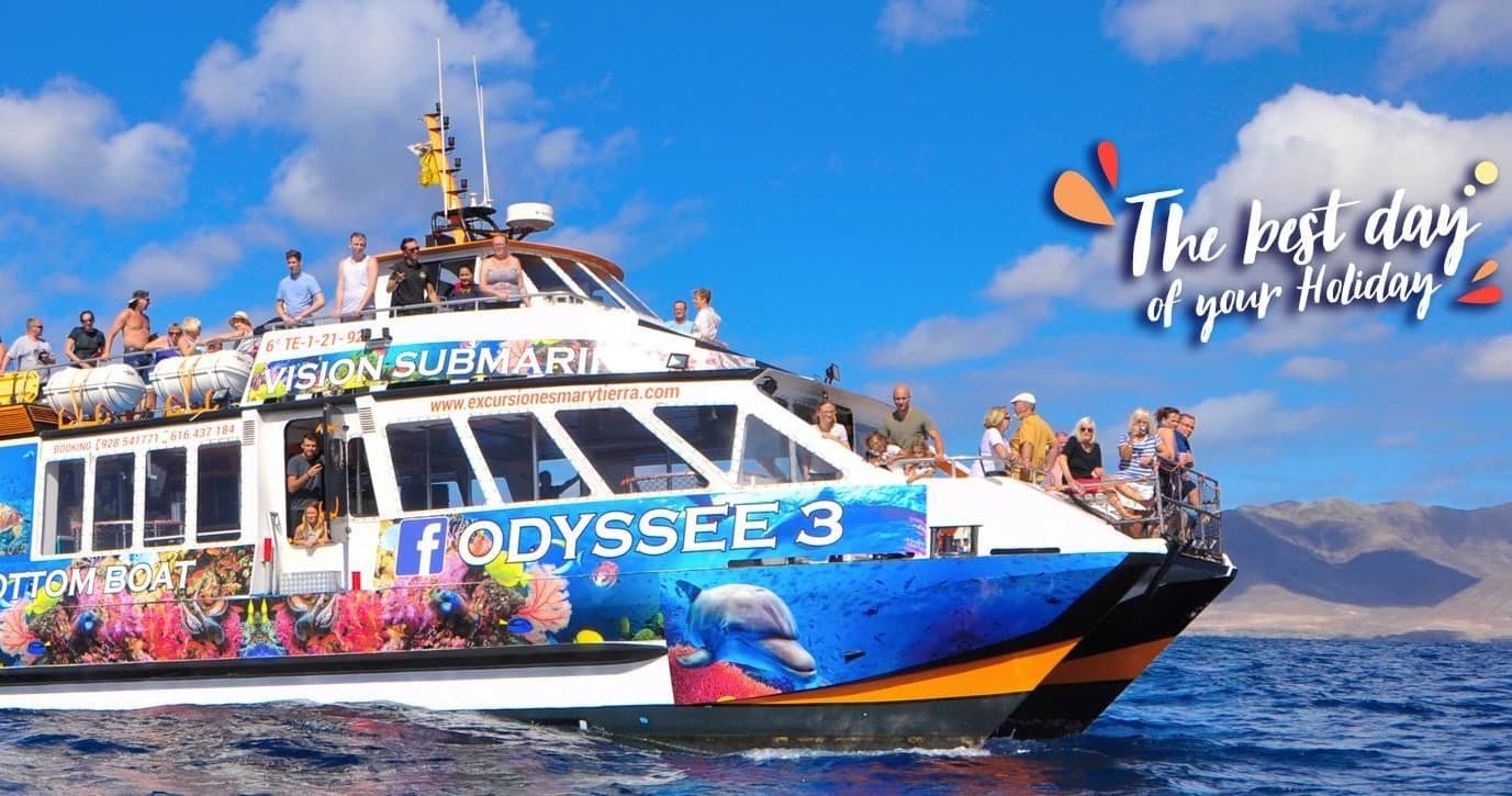 Colorful catamaran excursion with tourists off Fuerteventura coast