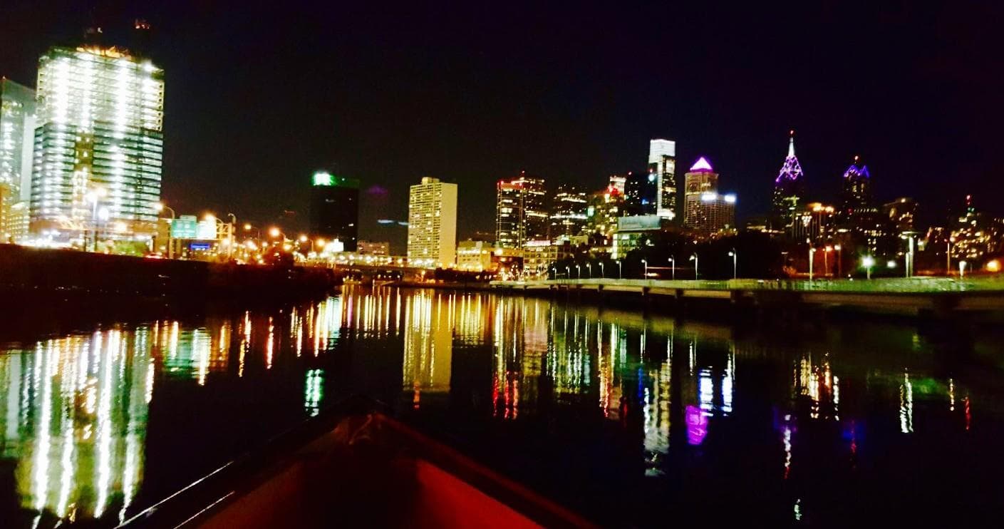 Nighttime Philadelphia skyline reflected from riverboat deck