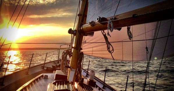 Sunset sailing view from cockpit with warm golden light