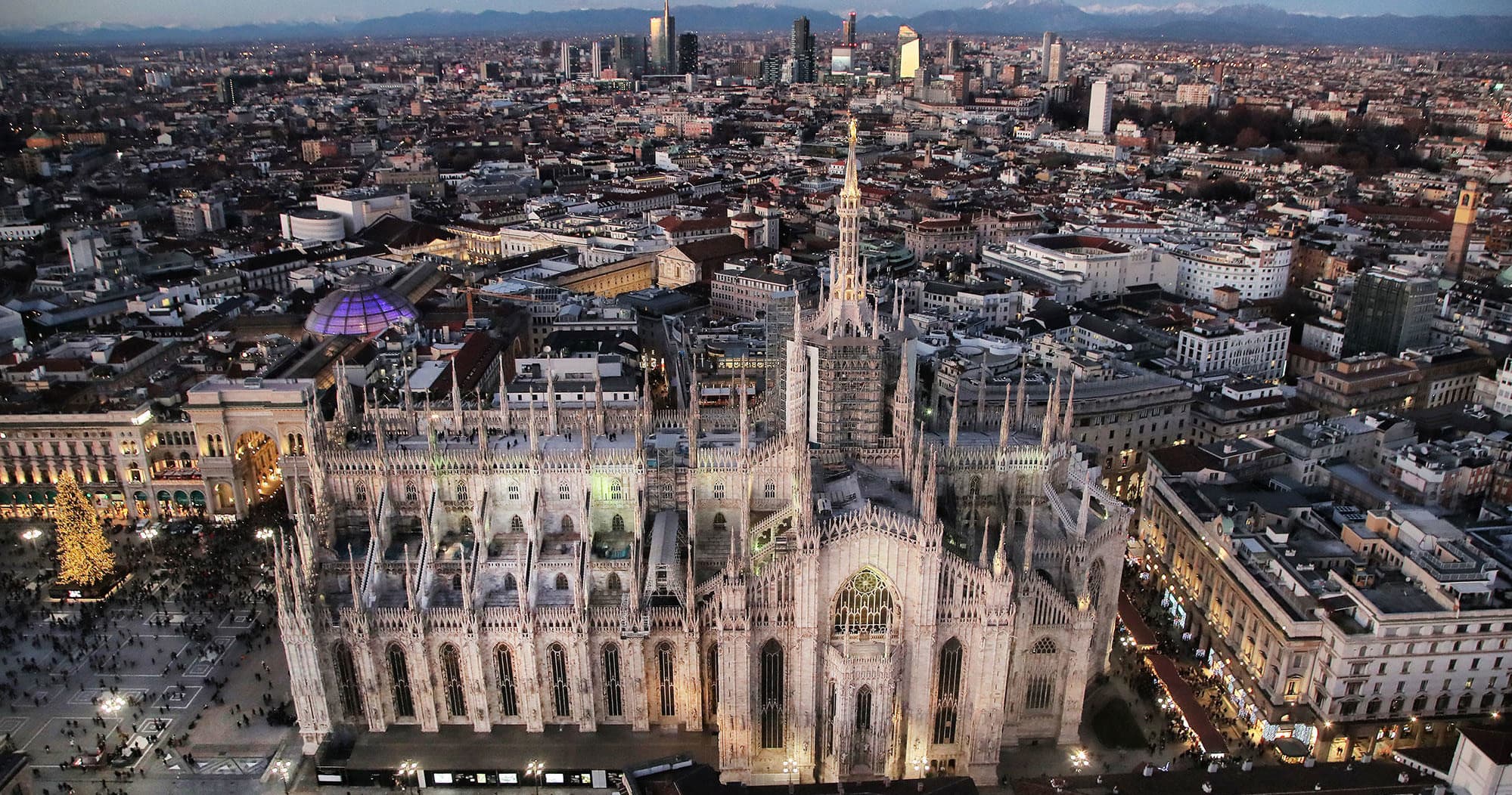 Aerial dusk view of Milan Duomo and city skyline, panoramic