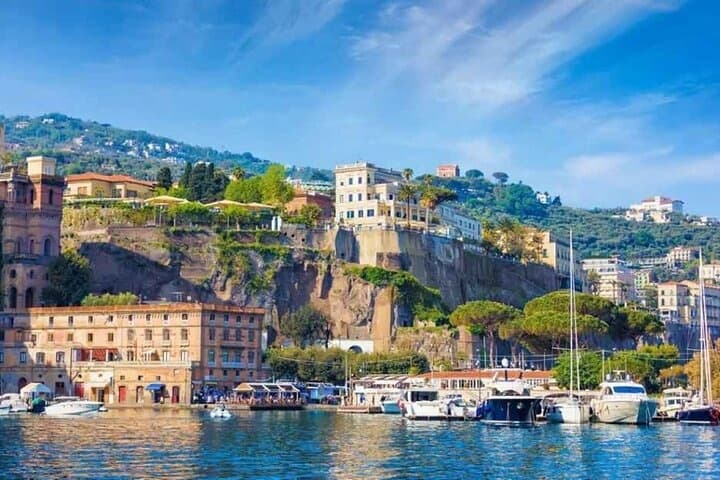 Boats moored along Amalfi Coast waterfront, scenic coastal sightseeing