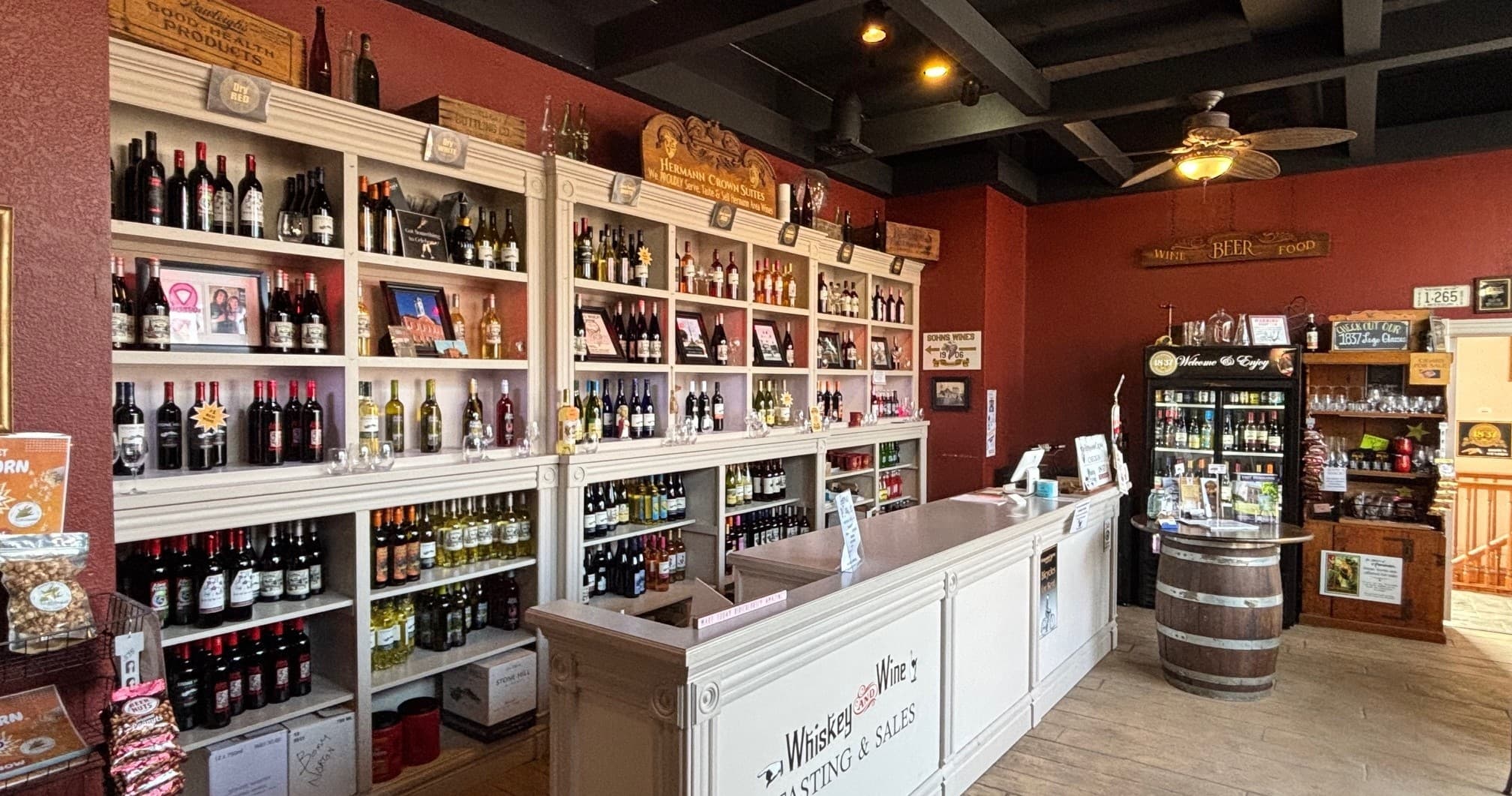 Wine shop interior with shelves and tasting counter in Hermann