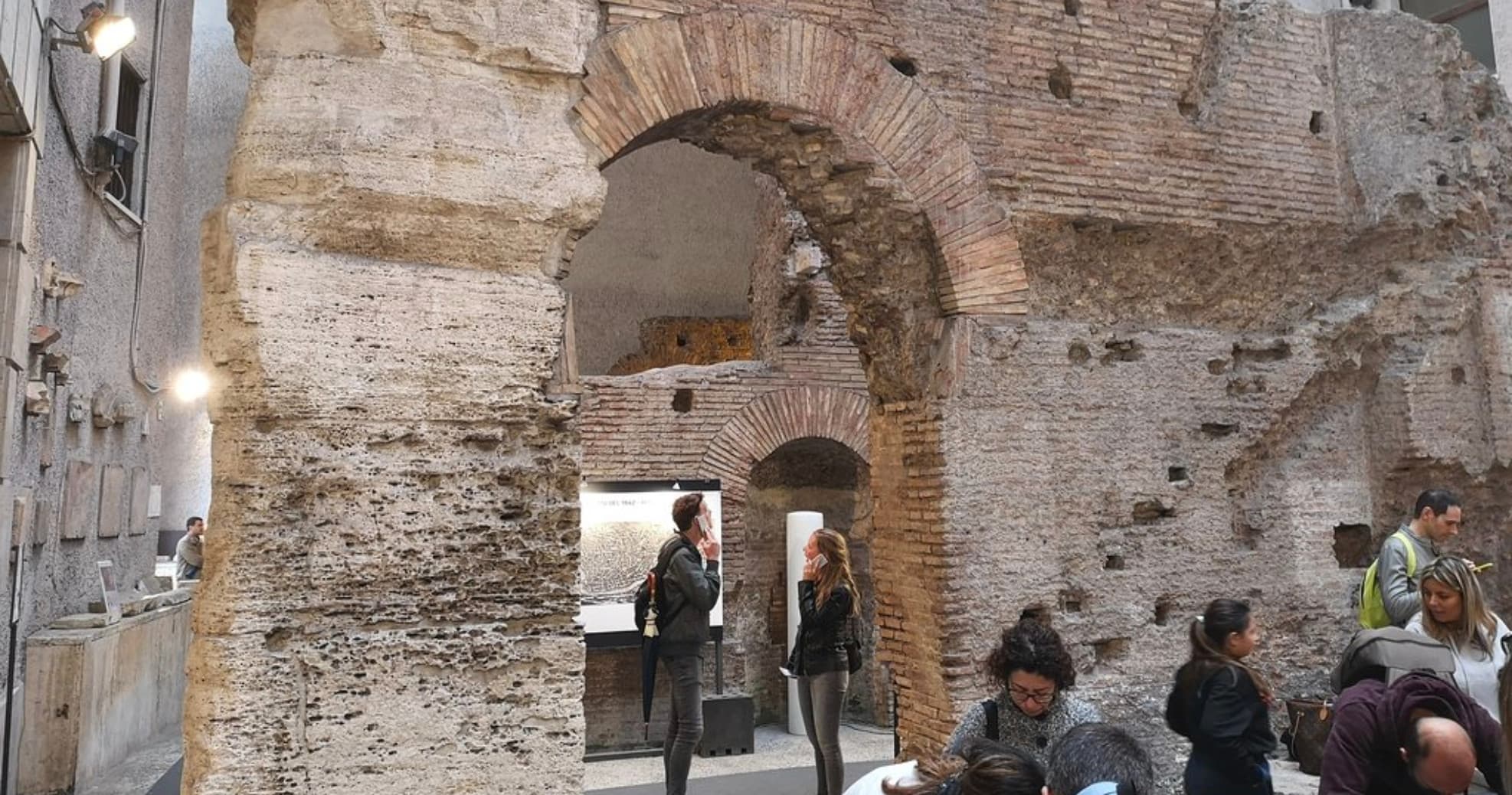 Visitors exploring ancient brick arches inside Domitian Stadium ruins, Rome