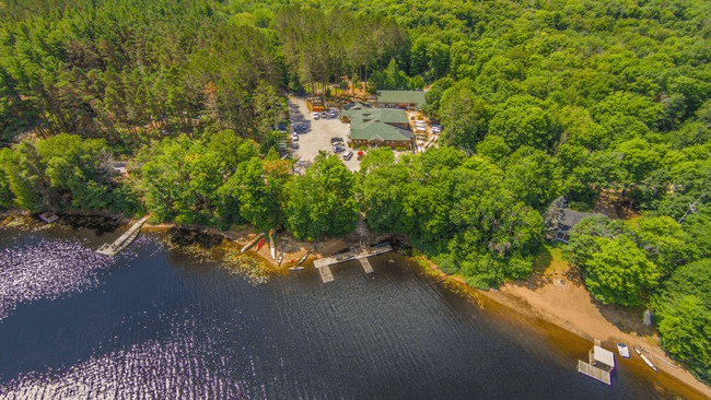 Aerial view of Lake of Two Rivers camp and wooded shoreline
