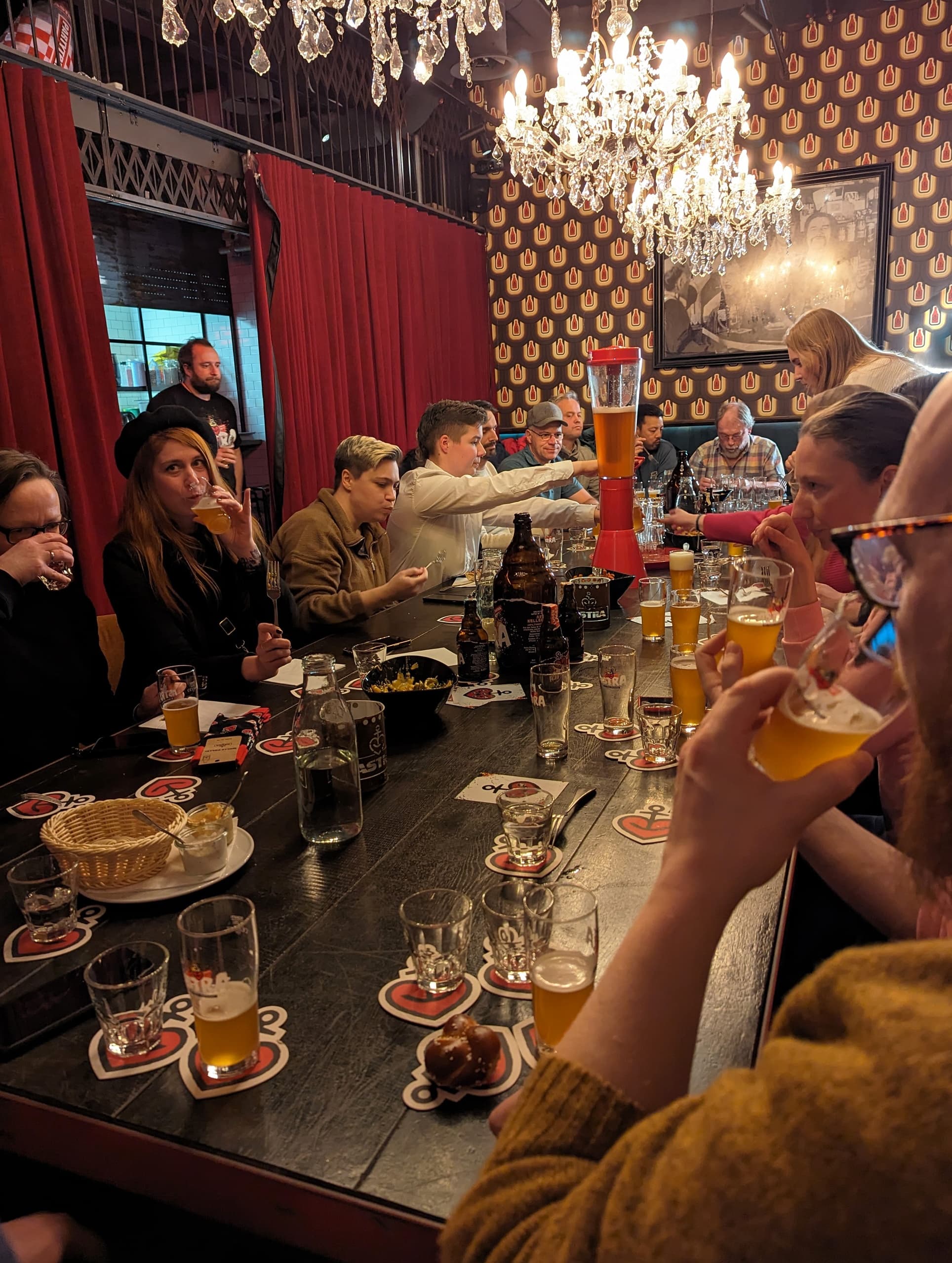 Group tasting beers inside Astra brewery taproom with bar seating