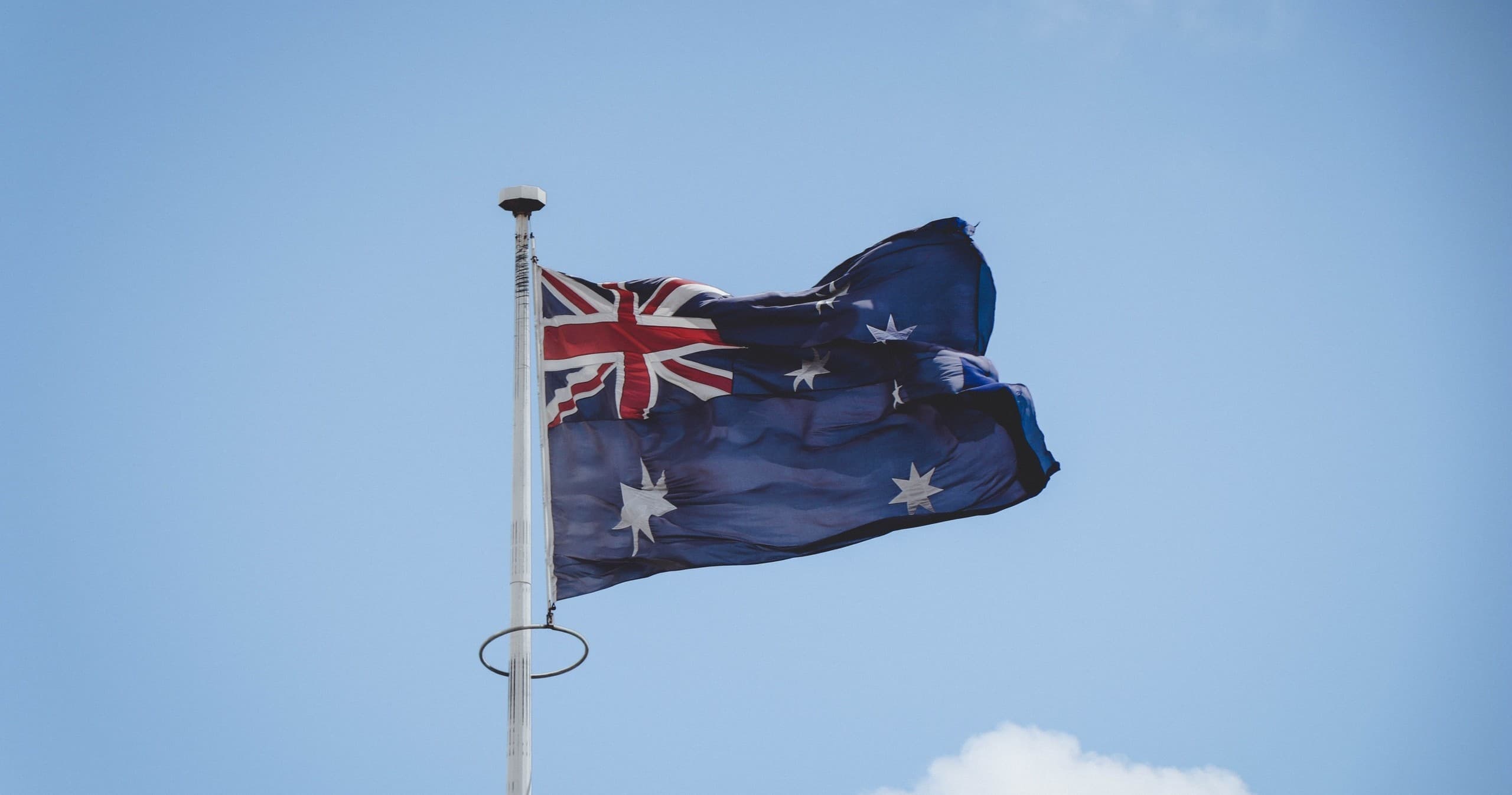 Australian flag waving against blue sky at pioneer village