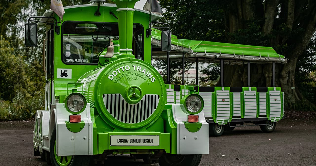 Bright green tourist tram parked outdoors for guided city tours