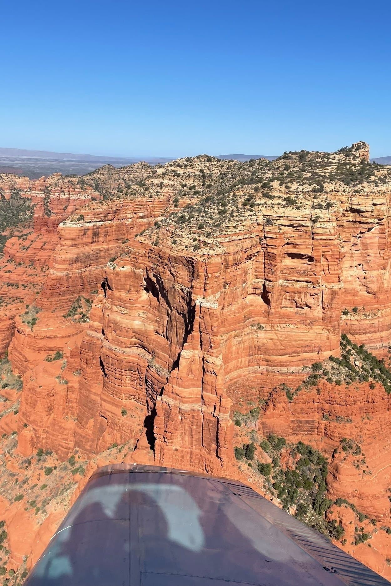 Aerial canyon sightseeing showing red cliff crevasse, desert vista