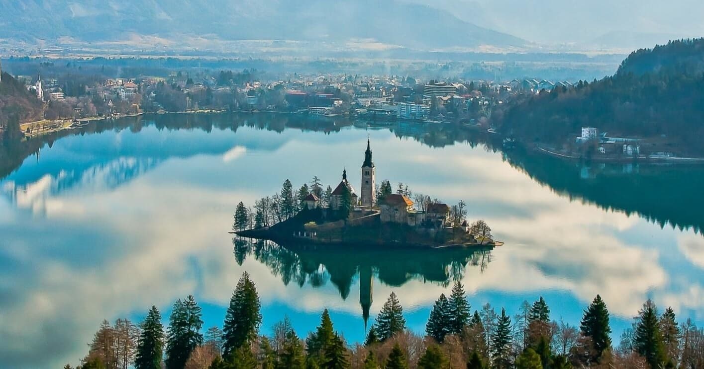 Aerial view of Lake Bled island church, serene alpine boating